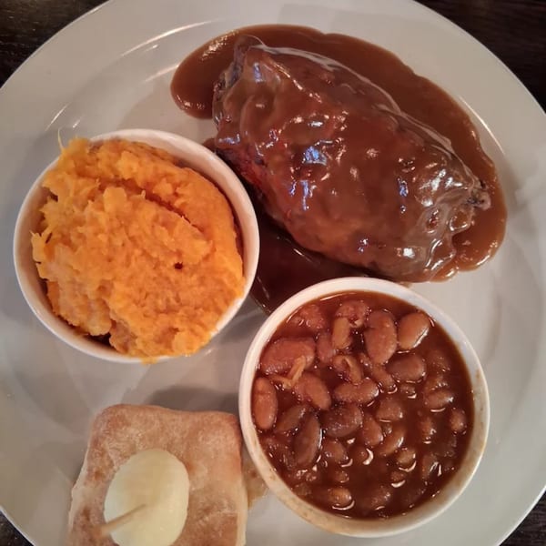 Annie O's Kitchen's southern meal with meatloaf, mashed sweet potatoes, baked beans, and cornbread.