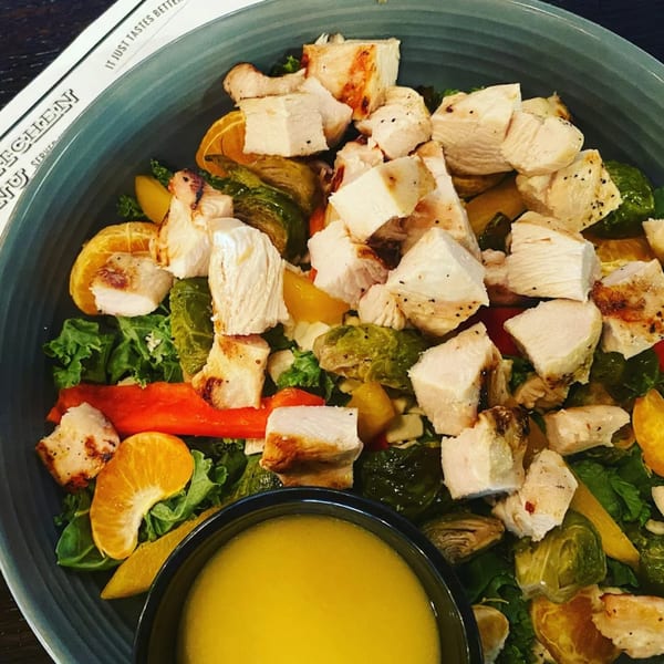 Annie O's Kitchen's southern salad with grilled chicken, brussels sprouts, oranges, and dressing.